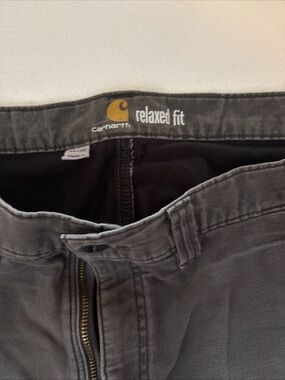Carhartt Relaxed Fit Cargo Pants in Charcoal Gray tattered with holes